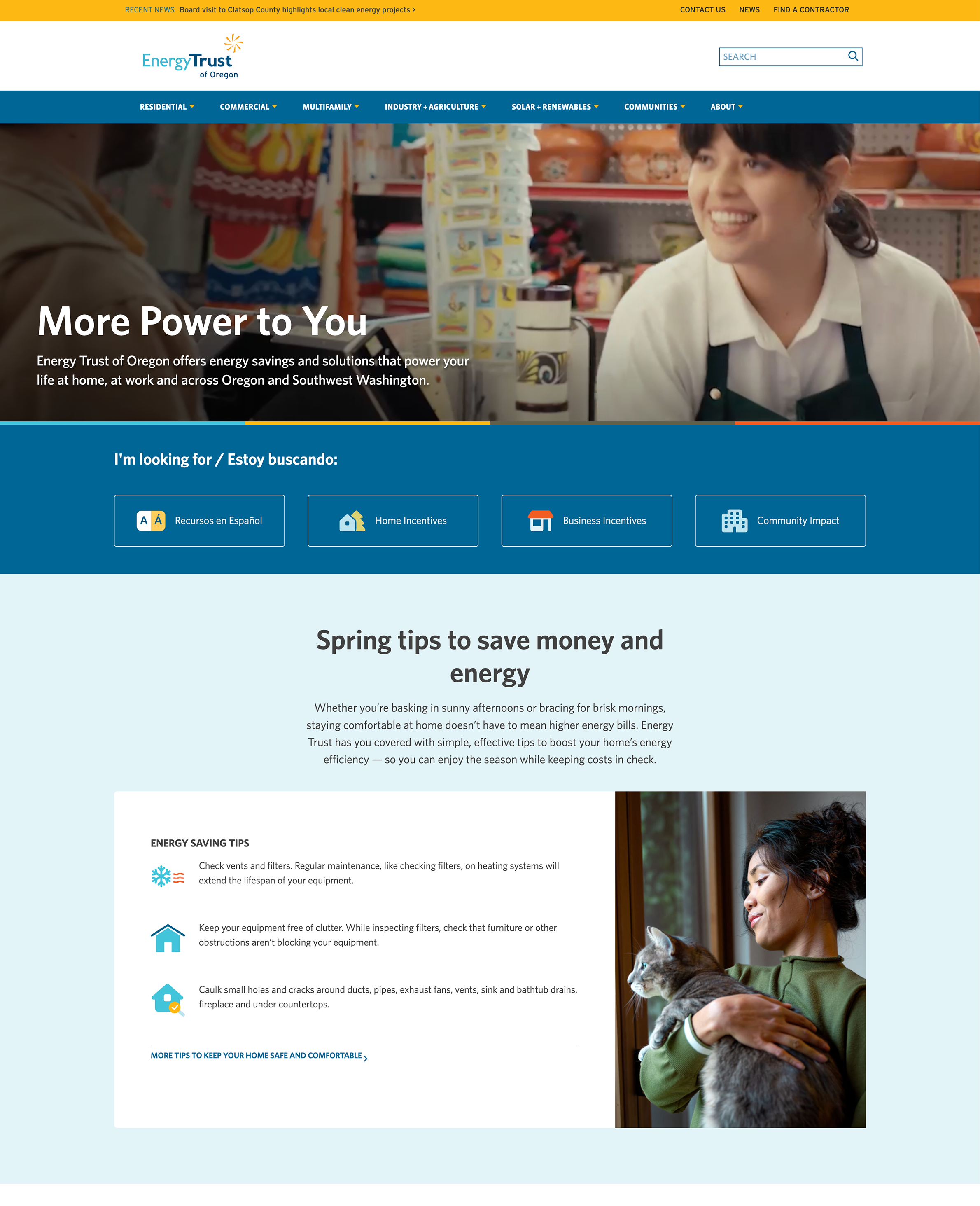 A screenshot of the Energy Trust of Oregon website homepage, featuring a smiling young woman in a shop apron in the hero banner, navigation links for residential, commercial, and other energy services, a bilingual resource finder section in English and Spanish, and a spring energy saving tips section with a photo of a woman holding a cat near a window.